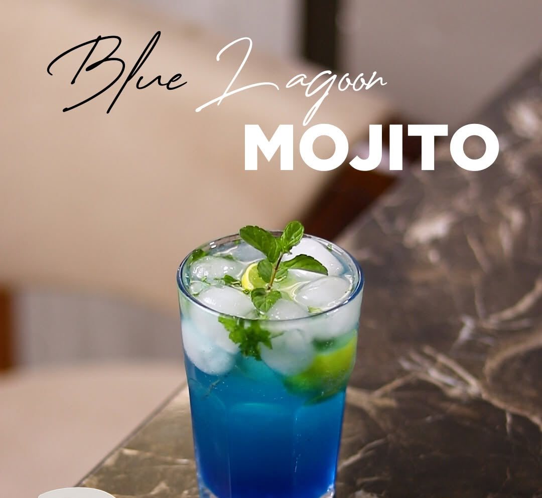 A blue and white mojito cocktail in a clear glass with ice, mint leaves, and lime slices, set on a dark marble table with promotional text overlays including 'Blue Lagoon Mojito', a '2 Anniversary' badge, and a 'Discount 30% OFF' sticker.