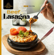 A restaurant menu or promotional card for Carro Edeg Hotel featuring a photo of Beef Lasagna. The image shows a hot black stone plate with melted cheese, tomato slices, and herbs, with a hand holding a fork lifting a piece of the lasagna.