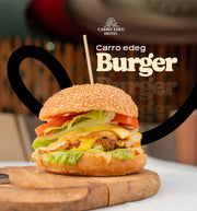 A gourmet burger with a sesame bun, melted cheese, lettuce, and tomato on a wooden board, with Carro Edeg Hotel branding and contact information overlaid on the image.